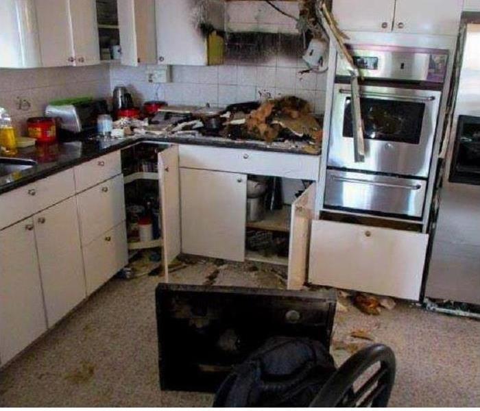 charred kitchen, appliance on floor, burned apron