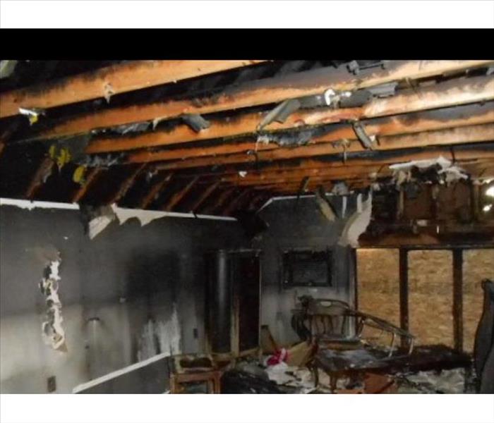 fire damage room, plywood board up, black walls